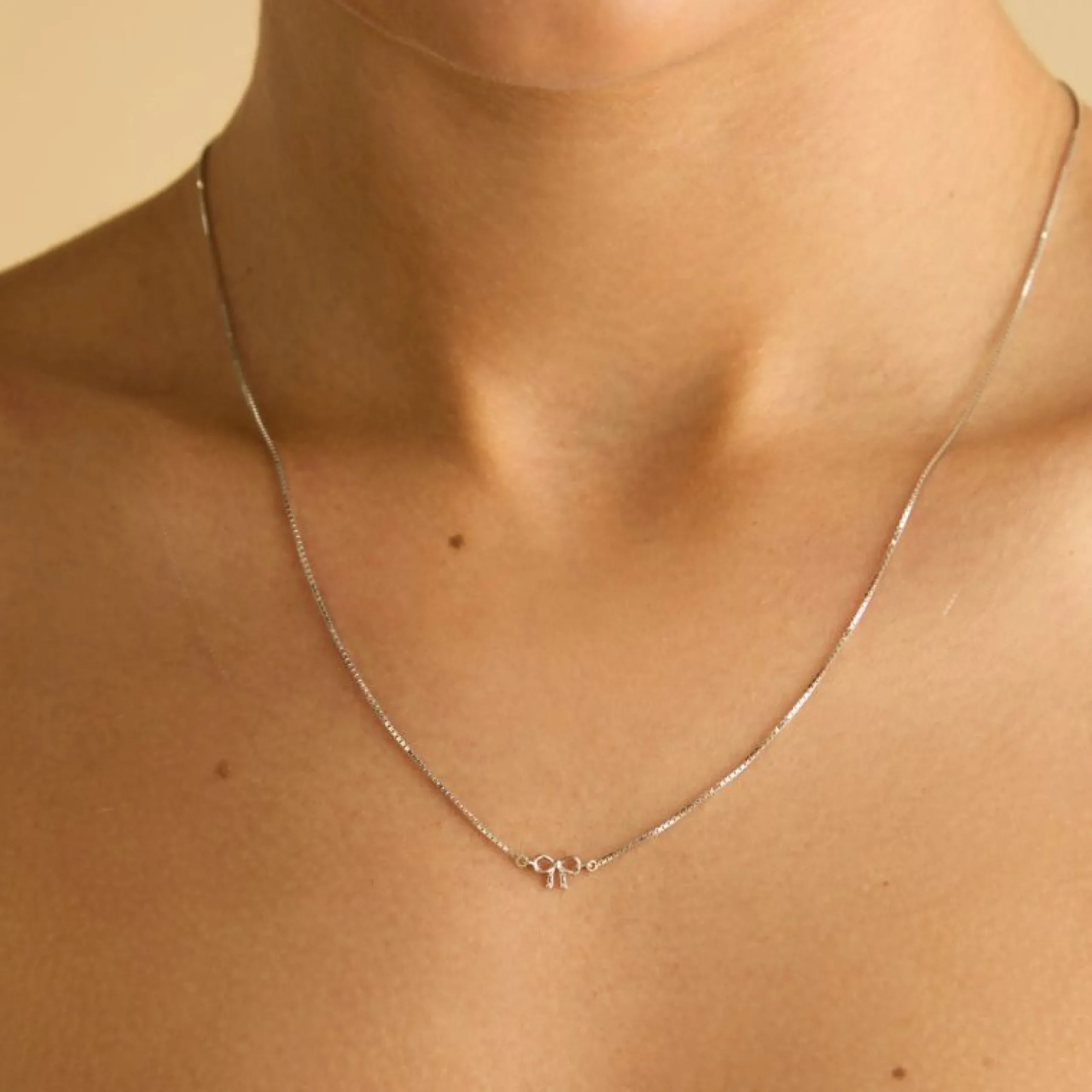 bow_charm_necklace_in_sol_1-1.webp Bow Charm Necklace in Solid White Gold