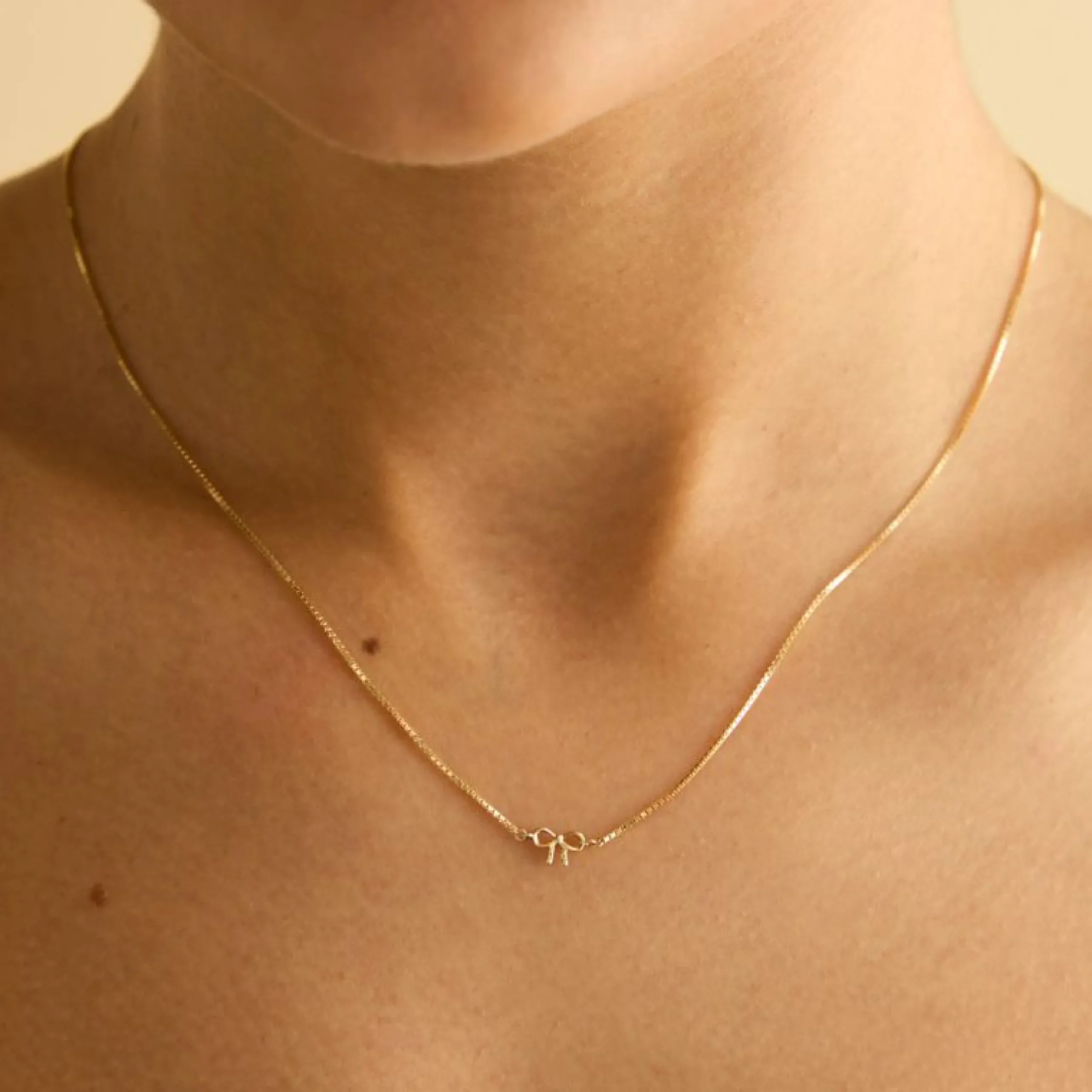 bow_charm_necklace_in_sol_1.webp Bow Charm Necklace in Solid Gold