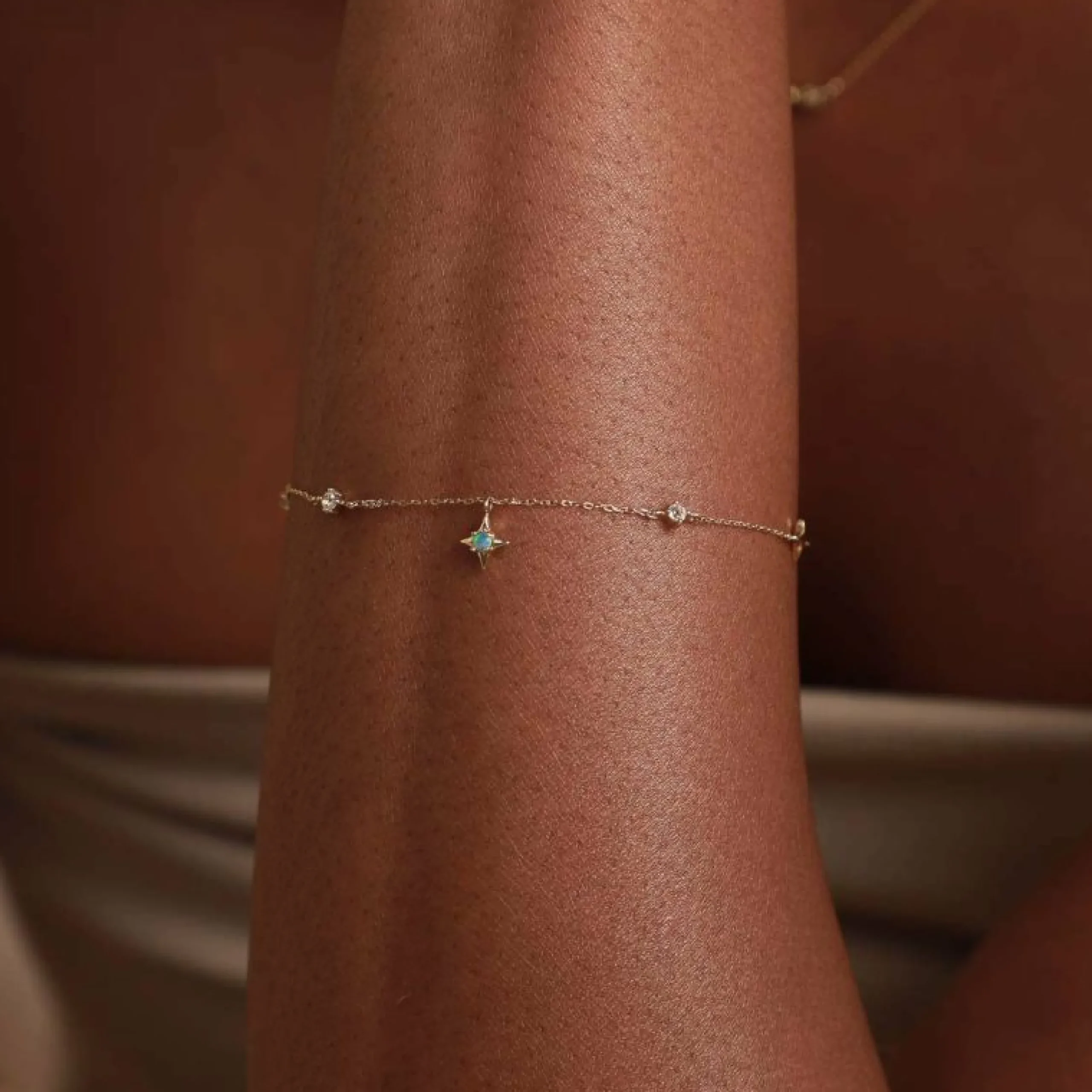 cosmic_star_opal_charm_br_1.webp Cosmic Star Opal Charm Bracelet in Solid Gold
